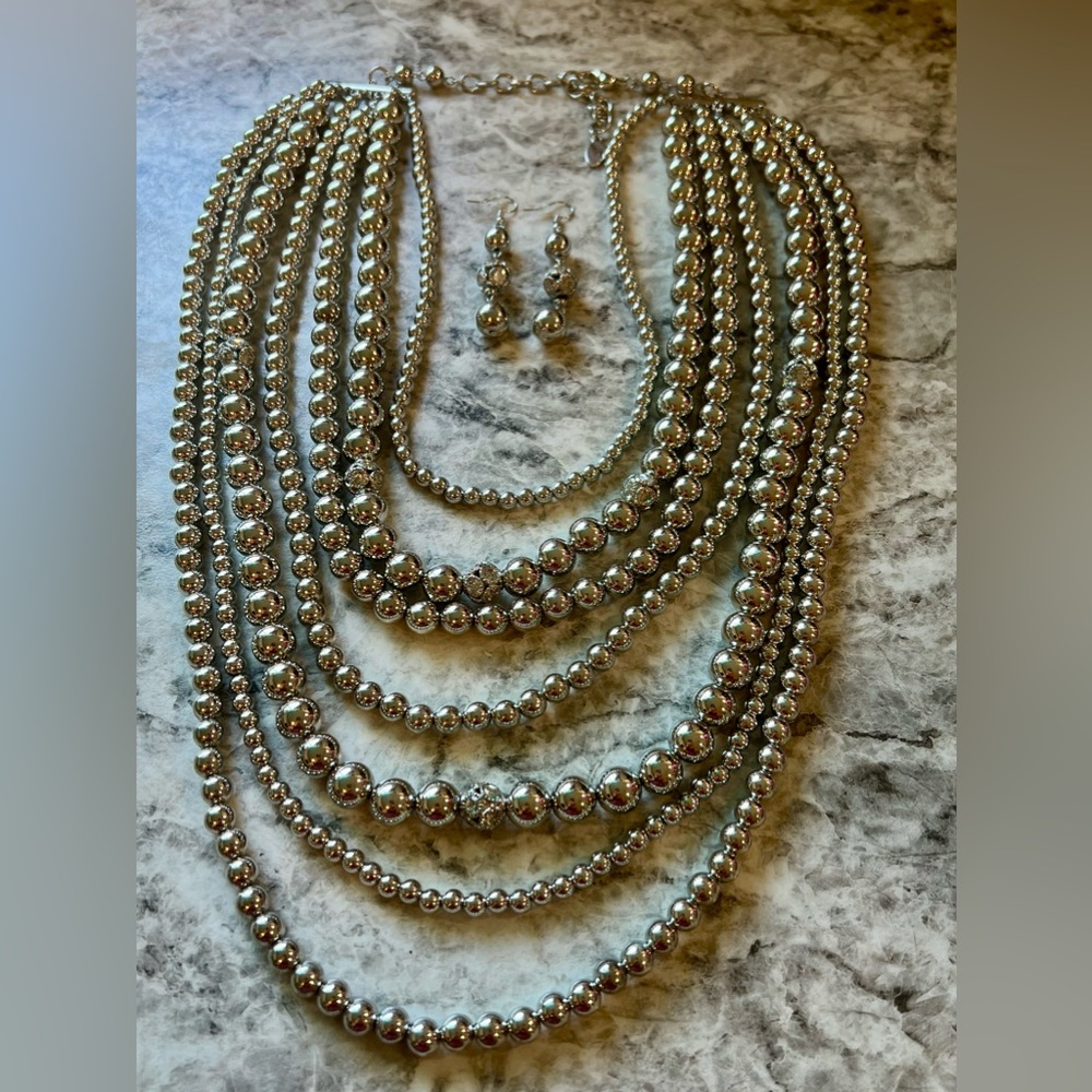 Shimmery layered silver beaded necklace with matching earrings